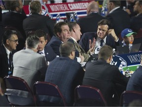 Jim Benning, Francesco Aquilini and some of the Vancouver Canucks' scouting staff at the 2019 NHL Entry Draft in Vancouver.