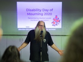 Abuse victim Bill MacArthur speaks during Eighth annual Disability Day of Mourning at Burnaby Neighbourhood House on Sunday.
