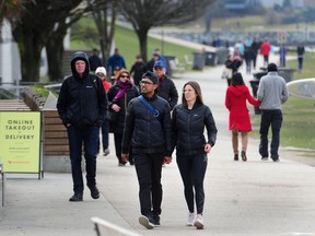 Walkers and runners along English Bay as health officials have recommended strict social distancing to prevent the spread of COVID-19 in Metro Vancouver.