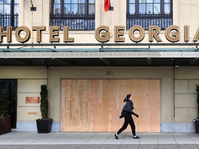 The Hotel Georgia is boarded up as a number of retail shops on Robson have boarded up windows to prevent looting during the COVID-19 closures in Vancouver, B.C., March 29, 2020.