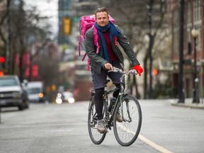 Tom Pawlak delivers meals by bike for Foodora during the COVID-19 crisis in Vancouver on March 30.