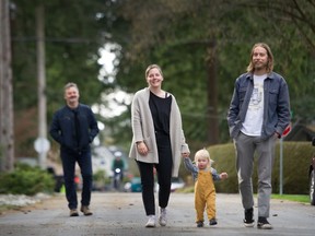 Emily McMartin and her husband Brad Felotick walk in their Tsawwassen neighbourhood with their daughter Hazel and — respectfully in the background — Emily’s father and former Vancouver Sun columnist Pete McMartin.