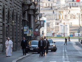 This handout picture released by the Vatican Media shows Pope Francis walking in an empty Via del Corso in Rome on Sunday, March 15, 2020.