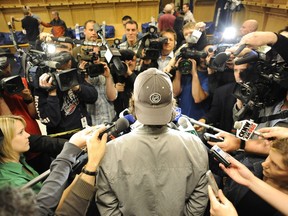 A Canucks player holds forth for Vancouver media in the team's dressing room in an end-of-season clearing out.