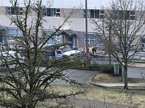 BC Hydro crews work to restore a damaged underground power cable at Aspenwood Elementary School in Port Moody. A city pipe ruptured overnight Tuesday. [PNG Merlin Archive]