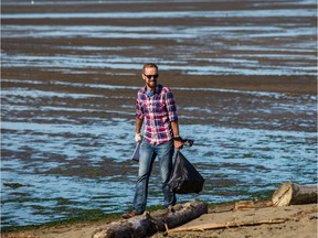 Cleanup crews work along the shoreline at Iona Beach Regional Park.