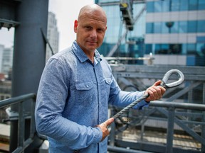 FILE PHOTO: Aerialist Nik Wallenda holds a sample of a wire while he speaks with media as he prepares for a highwire walk over Times Square in New York, U.S., June 20, 2019.