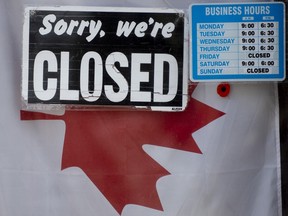 A 'Closed' sign hangs in a store window on April 16, 2020.