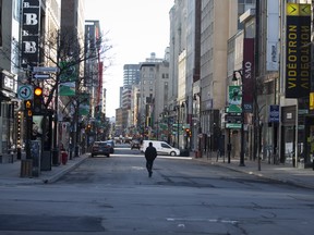 A pedestrian walks down Saint-Catherine Street in Montreal, Quebec, Canada, on Friday, March 27, 2020.