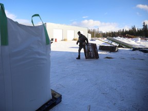 Jake Loos, Yukon Grain Farm employee, drags a pallet past bags of feed at the Yukon Grain Farm near Whitehorse, Yukon, Canada February 19, 2020. Picture taken February 19, 2020.