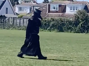 The 'plague doctor' of Norwich is seen on one of his walks.