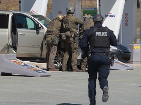 RCMP officers seen responding at a gas station in Enfield, N.S. on Sunday April 19, 2020.