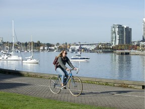 Cyclist on bike path on False Creek in Vancouver.