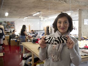 Liza Deyrmenjian shows off a completed mask at the Cutting Room aka The Cut Fashion Design Academy in Vancouver. A portion of the proceeds from Proceeds from the mask sales is being donated to AIDS Vancouver's food bank. (Mike Bell/PNG)