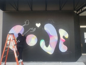 Hanna Lee Joshi works on her mural at 2915 South Granville as part of Make Art While Apart.
