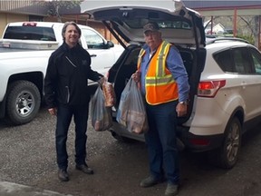 Calvin Dubray (left), principal of Marie Sharpe Elementary, and bus driver Bill Stafford load up groceries to be delivered to impoverished families in Williams Lake, some a four-hour drive away.