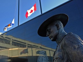 Flags of Nova Scotia and Canada fly at half-staff outside the Nova Scotia Royal Canadian Mounted Police (RCMP) headquarters in Dartmouth, Nova Scotia, Canada, on April 19, 2020, after a shooting rampage left at 17 dead.