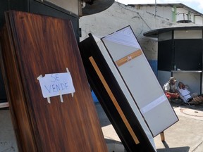 Coffins are displayed for sale outside Abel Gilbert Ponton Hospital in Guayaquil, Ecuador, on April 25, 2020. - Authorities in the port city of Guayaquil have recorded more than 22,000 cases of coronavirus, including 576 deaths. The government says there are an additional 1,060 probable COVID-19 deaths. Ecuador is Latin America's hardest hit country after Brazil.