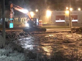 Work to try to mitigate flooding from Cache Creek, near the town's fire department, continued on Monday night.