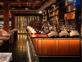 Chairs are turned upside down on the bar at a closed restaurant, amid concerns about the spread of the coronavirus, in Vancouver. Thousands of service industry staff are out of work during the COVID-19 pandemic.