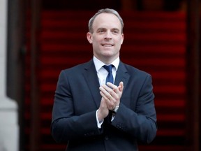 Britain's Foreign Secretary Dominic Raab applauds to show his appreciation for National Health Service staff working amid the COVID-19 outbreak, during the weekly "Clap for our Carers" event in London, England, Thursday, April 23, 2020. REUTERS ORG XMIT: BRI400