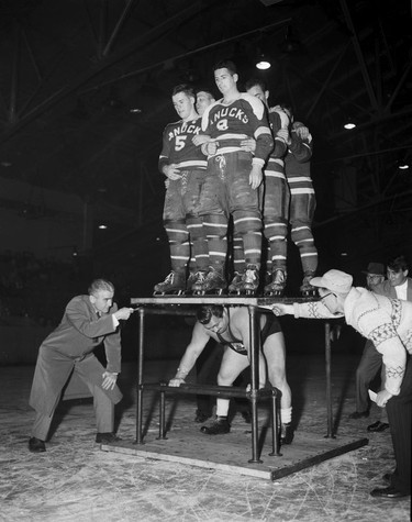 Oct. 2, 1954. Legendary Vancouver weightlifter and professional wrestler Doug Hepburn performs a feat of strength - lifting up a platform with six Vancouver Canuck hockey players up using his back. Roy LeBlanc/Vancouver Sun.