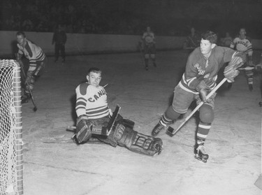 Vancouver Canucks goalie Lorne (Gump) Worsley in action against the New York Rangers. Worsley played for the Canucks in the 1953-54 season, and this is probably from an exhibition game on Sept. 30, 1953 at the Forum. The Canucks were the farm team for the Rangers at the time, but won 2-1. Ralph Bower collection.