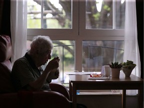 A resident eats alone in her room in a senior's home.