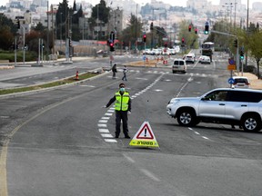 Israeli police set a roadblock on a way in Jerusalem as they try to contain the spread of the coronavirus disease (COVID-19) from the densely populated neighborhoods where the infection rate is high, April 12, 2020.