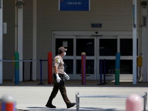 A Miami-Dade County police officer walks outside the passengers terminal where the Coral Princess ship, of Princess Cruises fleet, with patients affected by coronavirus disease (COVID-19), is docked at Miami Port, in Miami, Florida, U.S., April 4, 2020.
