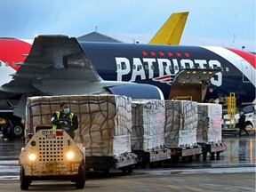 A New England Patriots Boeing 767-300 jet with a shipment of more than one million N95 masks from China —which will be used in Boston and New York to help fight the spread of COVID-19 — arrives at Logan Airport in Boston, Mass. on Thursday.