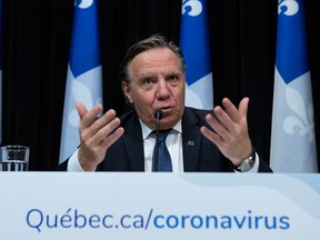 Quebec Premier Francois Legault, who did not a briefing Sunday responds to reporters during a news conference last week on the COVID-19 pandemic.