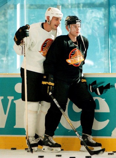 Sep. 12, 1996 -- Buddies Gino Odjick and Pavel Bure chat during Thursday morning Canuck training session in Whistler. Province photo by Bonny Makarewicz.