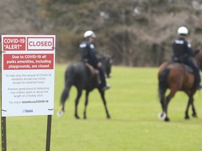 Toronto police monitor the entrance to High Park, to enforce social distancing, on April 5.