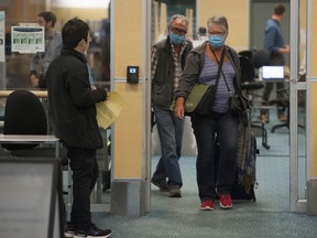 Cynthia and Vartan Temorcioglu of Chilliwack arrive on a flight from Dallas Friday. They were returning from a Mexican vacation. Extra precautions are being taken at Vancouver International Airport because of the novel coronavirus pandemic.