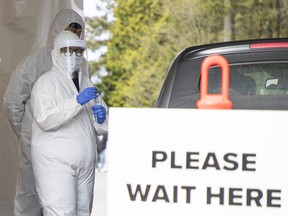 Health officials conduct testing and interview potential coronavirus patients at the Central Park COVID-19 primary care testing and treatment site in Burnaby on March 17.