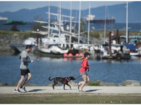 Joggers at Vanier Park in Vancouver, BC Saturday, April 18, 2020.