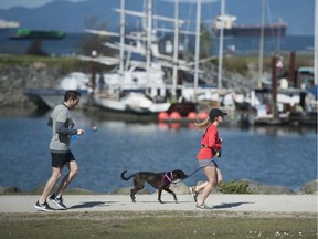 Registered massage therapists will be off work until at least June. 
Joggers at Vanier Park, Vancouver, B.C. April 18, 2020.