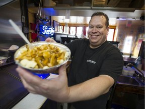 Pascal Cormier prepares an order of poutine at his Davie Street restaurant La Belle Patate. Due to the COVID-19 pandemic, farmers are uncertain about how many potatoes to plant for next year.