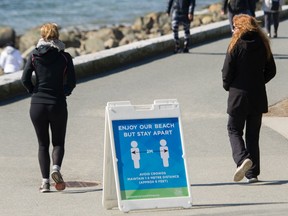 Social distancing sign  on the seawall at Stanley Park.