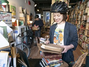 Kim Koch and Rod Clarke of Paper Hound Books put together packages of books ready for delivery, in Vancouver on April 13.