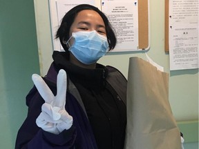 A Chinatown community volunteer from the Yarrow Intergenerational Society for Justice drops off a bag of groceries to seniors in Chinatown and Strathcona during the pandemic.