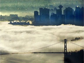 Vancouver and the Lions Gate Bridge seen through the fog.