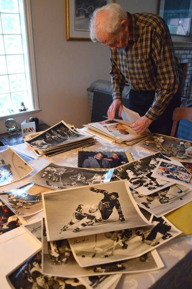 Former Vancouver Sun photographer Ralph Bower going through old prints of Vancouver Canucks games he photographed, Jan. 21, 2020. John Mackie/PNG