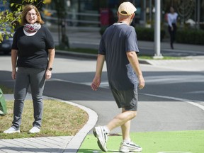 Sandy James (left) of the Walk Metro Vancouver Society, pictured last summer. James says one way to offer more space for walkers on downtown commercial streets is to allow pedestrians and rollers to spill into the adjacent metered parking lanes, narrowing the portion of the road surface for vehicles to only two lanes.