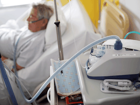 A COVID-19 patient uses a ventilator at a hospital in Vannes, France.