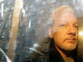Buildings are reflected in the window of a car as WikiLeaks founder Julian Assange is taken from court, where he appeared on charges of jumping British bail seven years ago, in London on May 1, 2019.