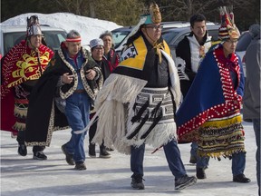 Wet'suwet'en hereditary chiefs walk prior to taking part in a ceremony at the Kahnawake Longhouse Saturday, February 22, 2020.