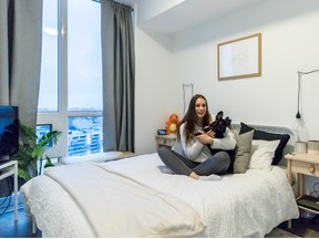 Penny Oleksiak with Norman in her bedroom after she chills out after her long days of practice.