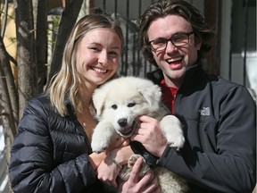 Alex Champagne (L) and Ben Robillard with their newly adopted dog, Wilson.